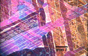 Image of a red, pink and blue crystalline pattern.